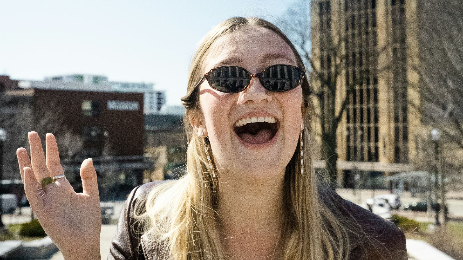 woman in brown sunglasses and brown shirt