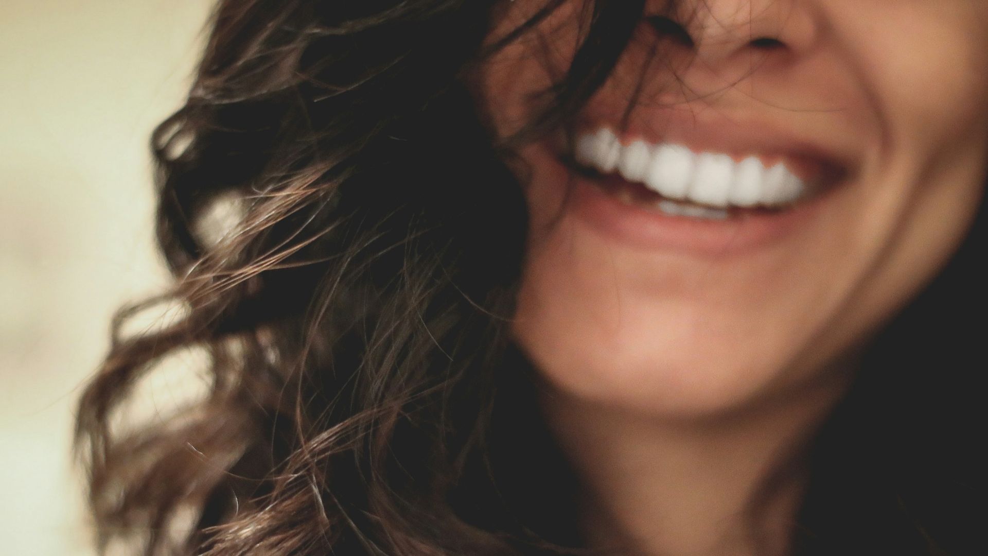 long black haired woman smiling close-up photography