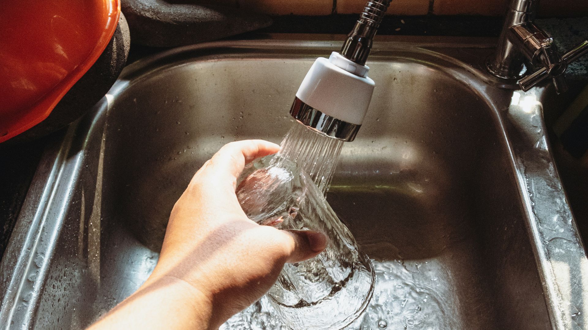 a hand holding a water bottle