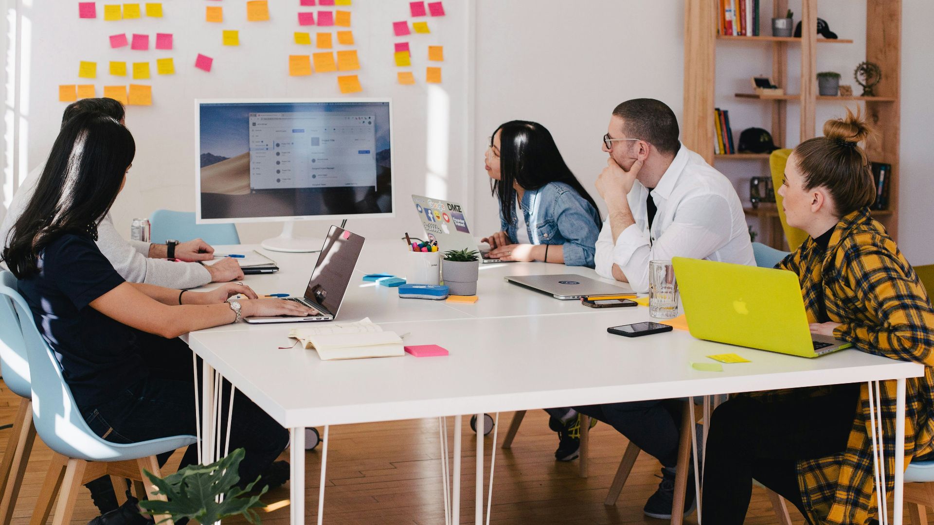 five person by table watching turned on white iMac