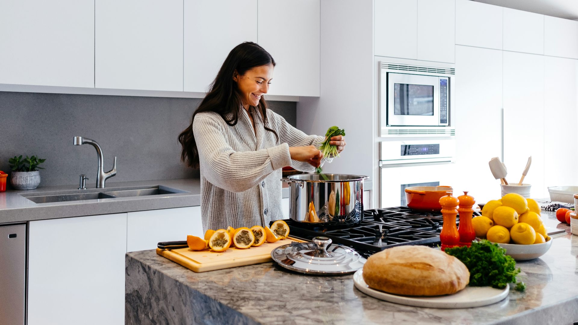 woman smiling while cooking