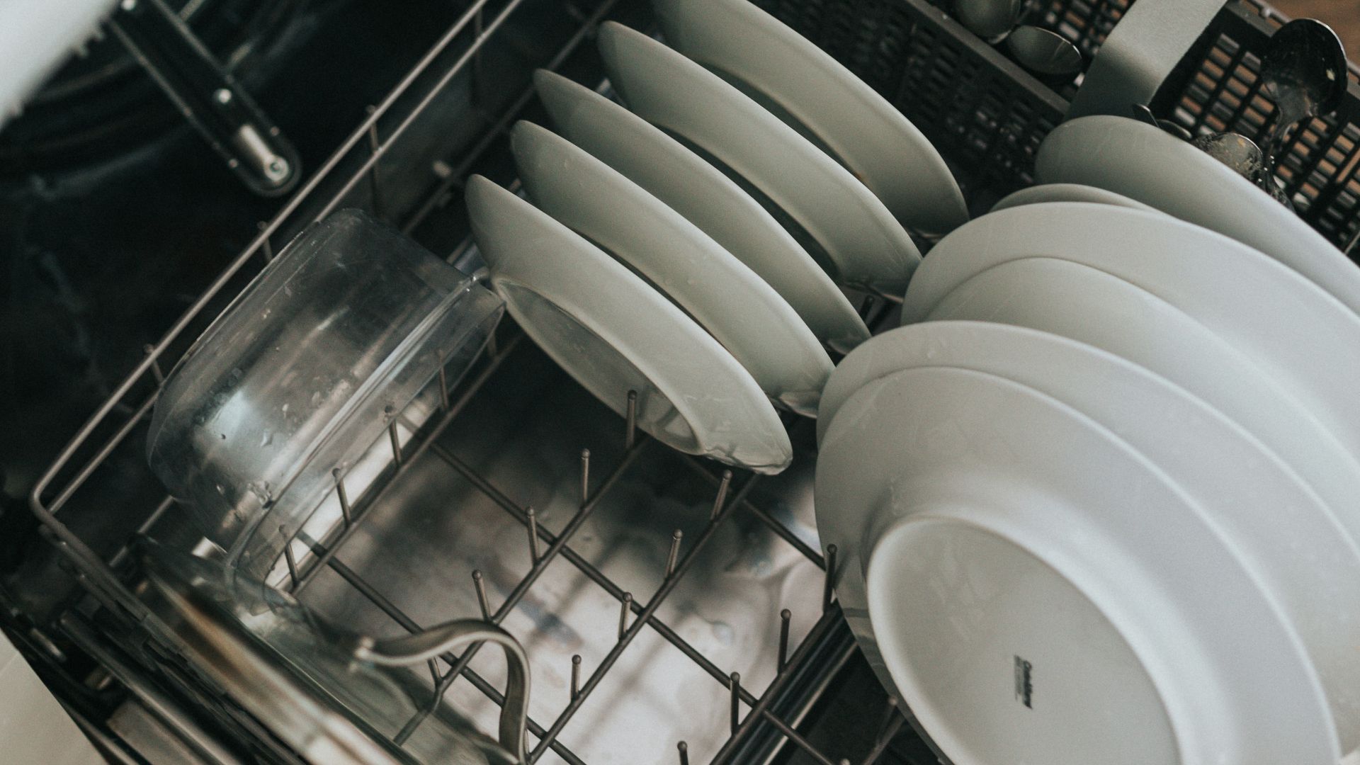 white ceramic plate on black dishwasher