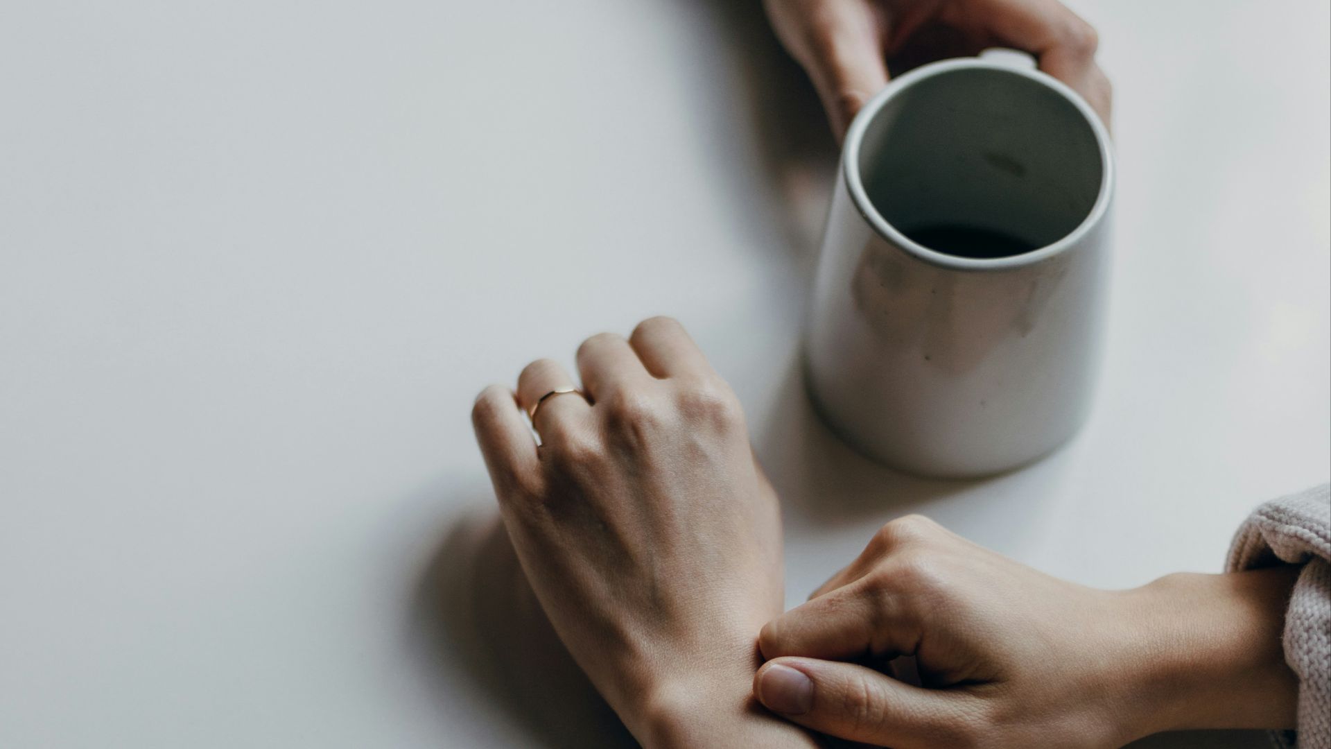 person holding white ceramic mug
