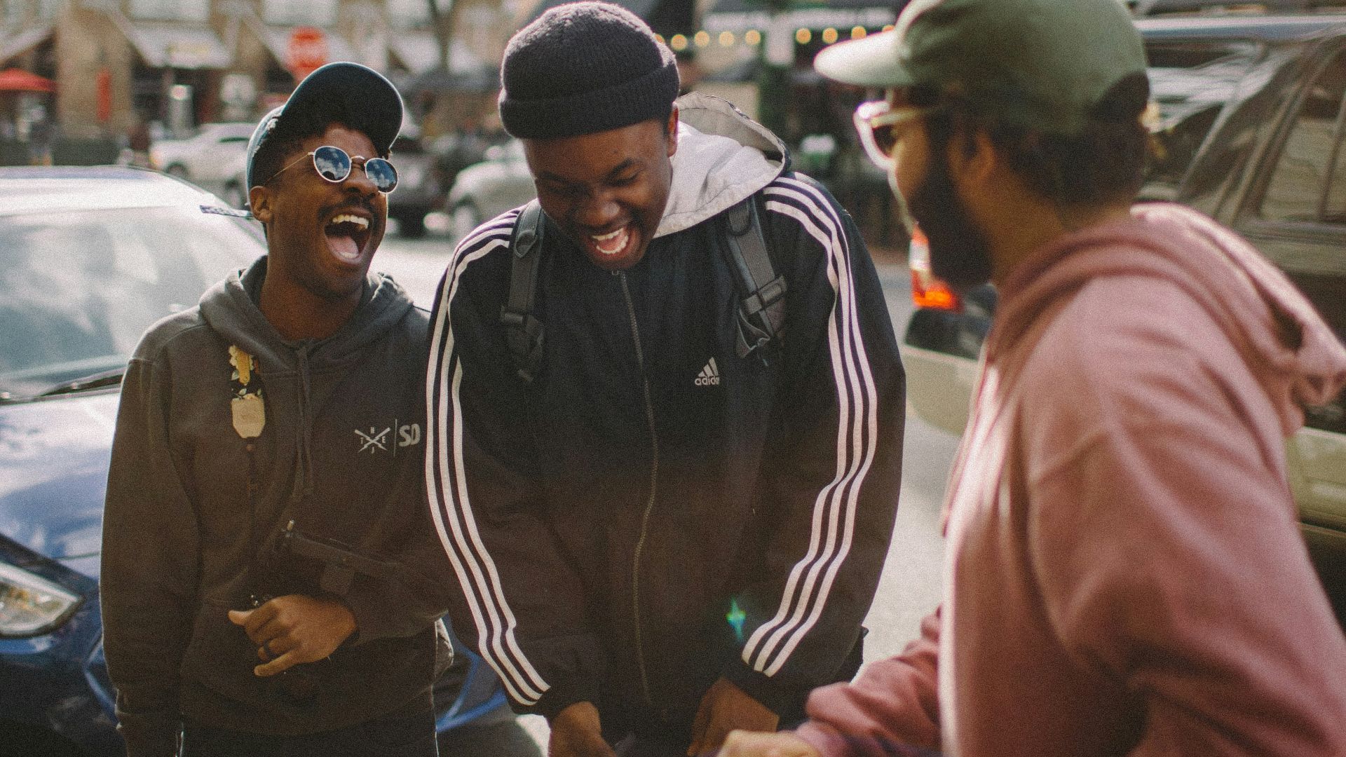three men in jacket laughing at each other