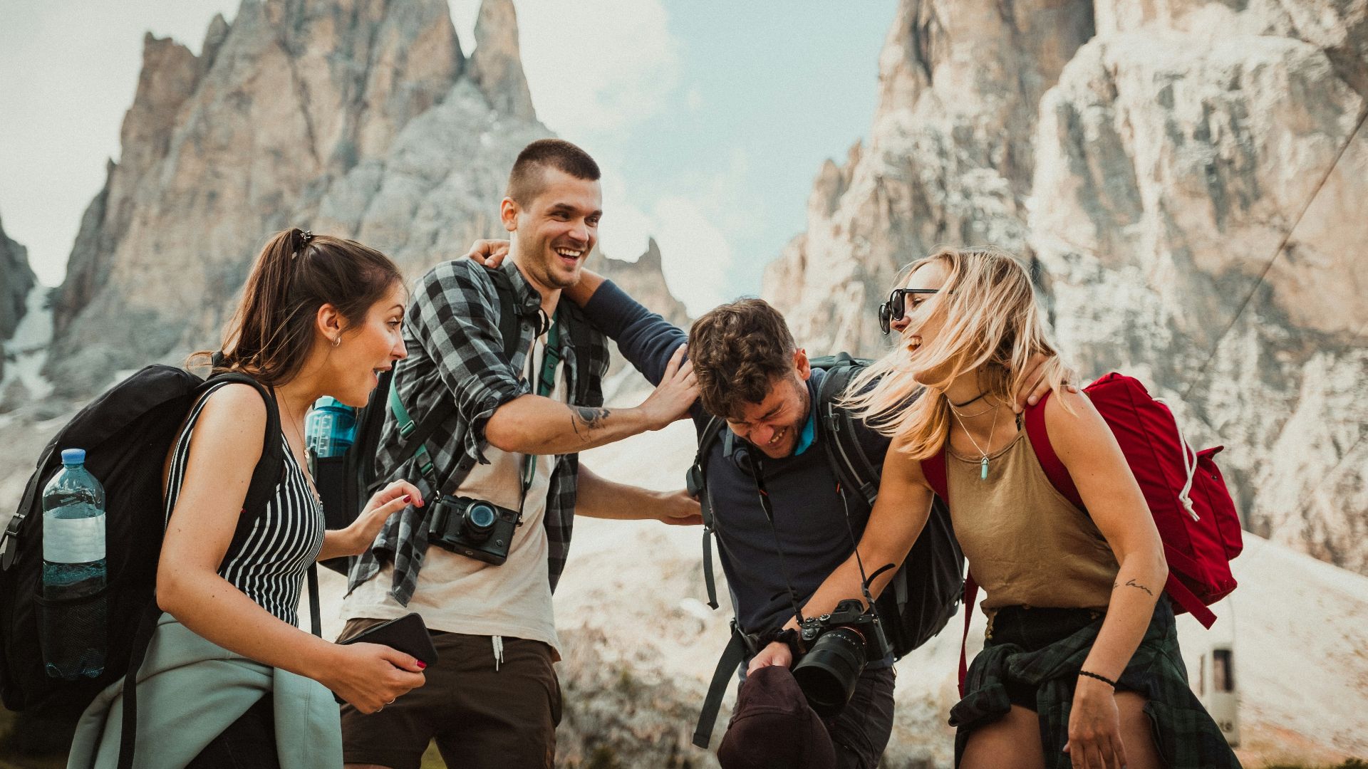 low-angle photography of two men playing beside two women