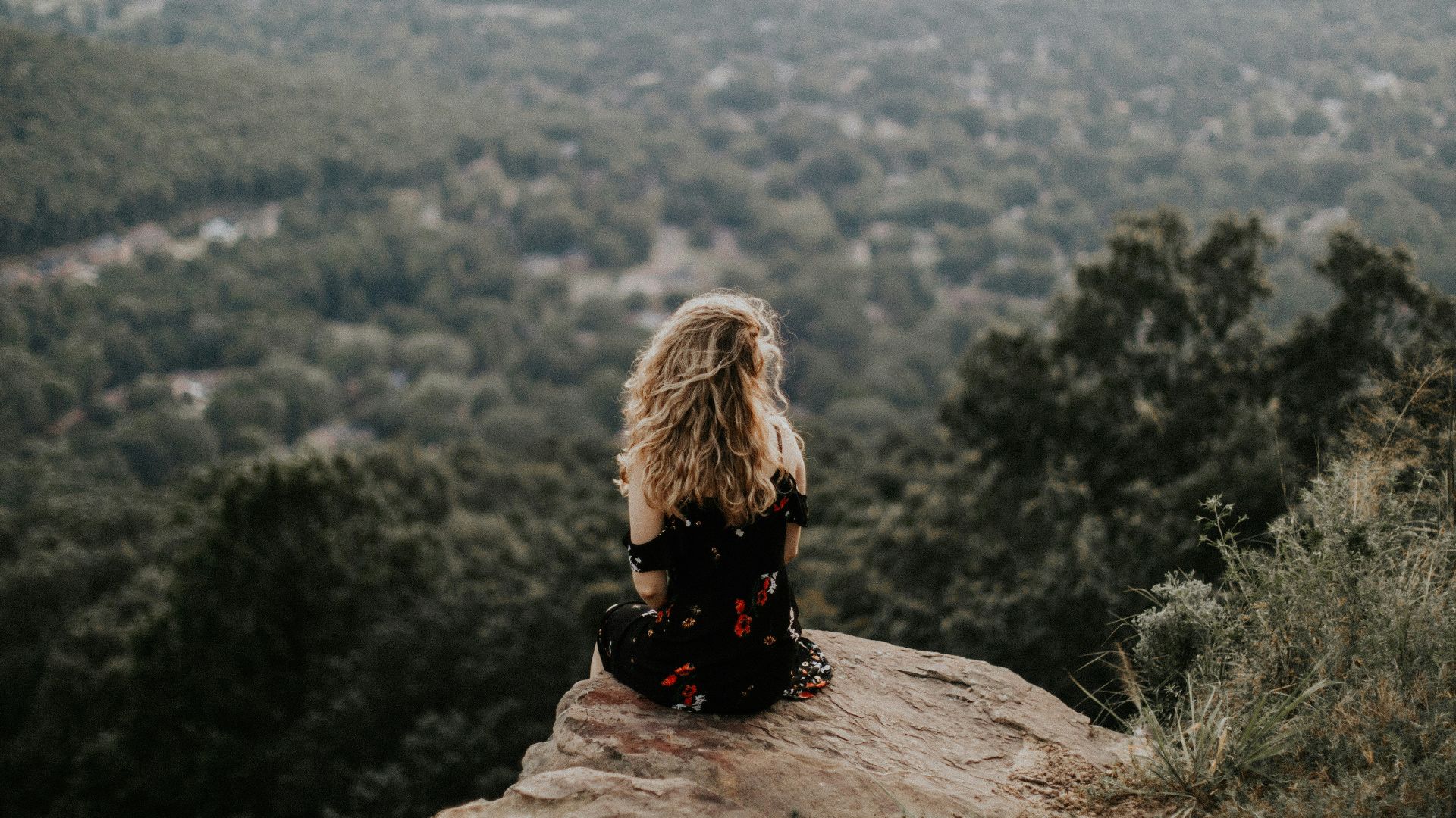 woman siting on cliff
