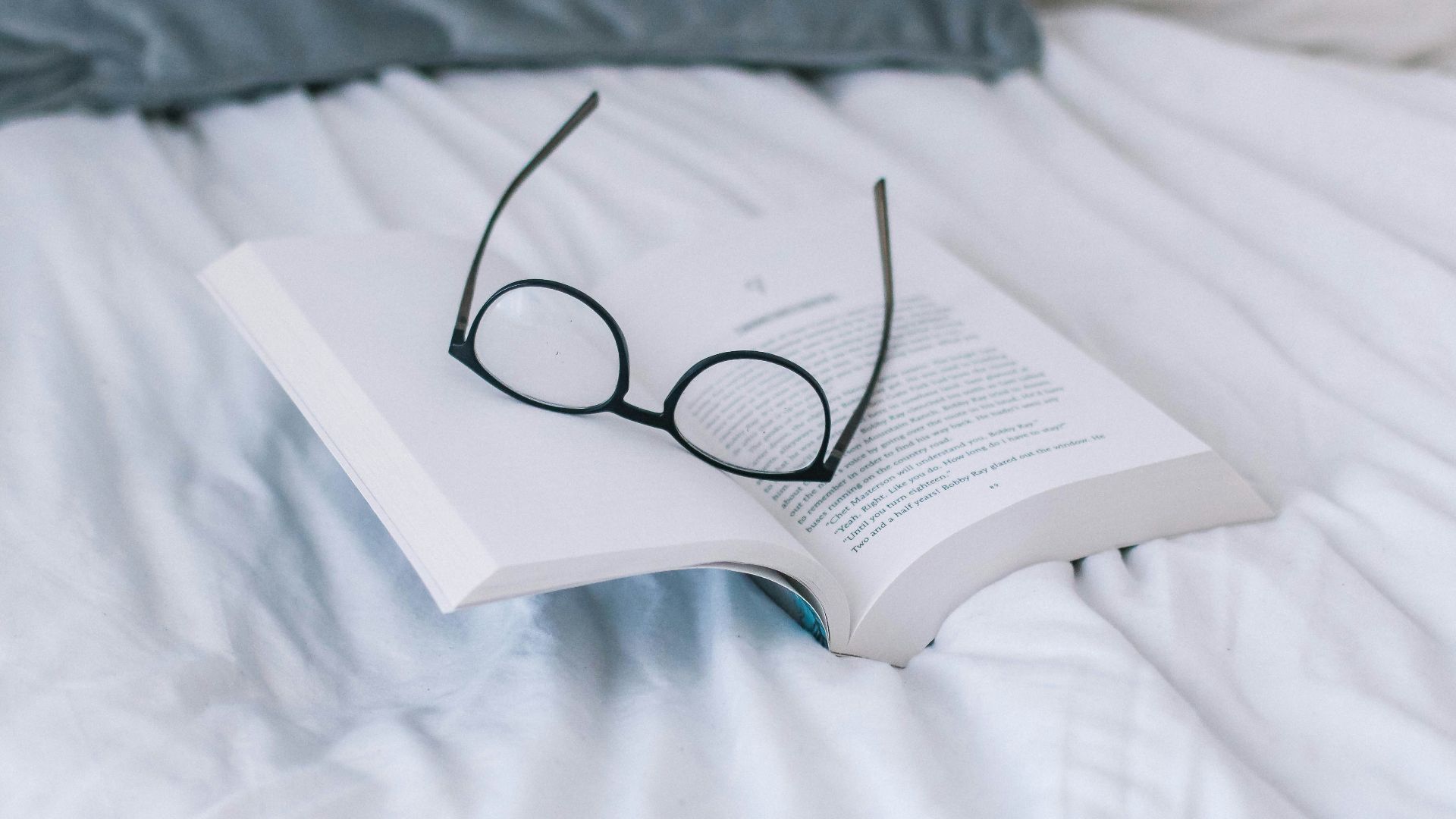 black framed eyeglasses on book page