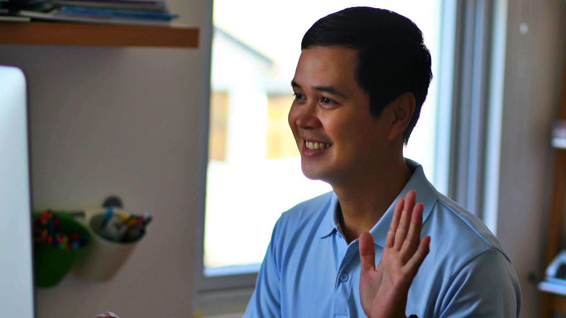 man in blue polo shirt smiling