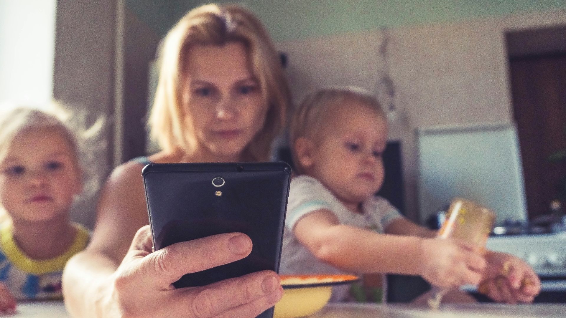 woman in white shirt holding black ipad