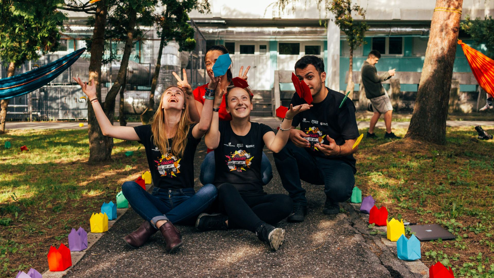 four people sitting near road