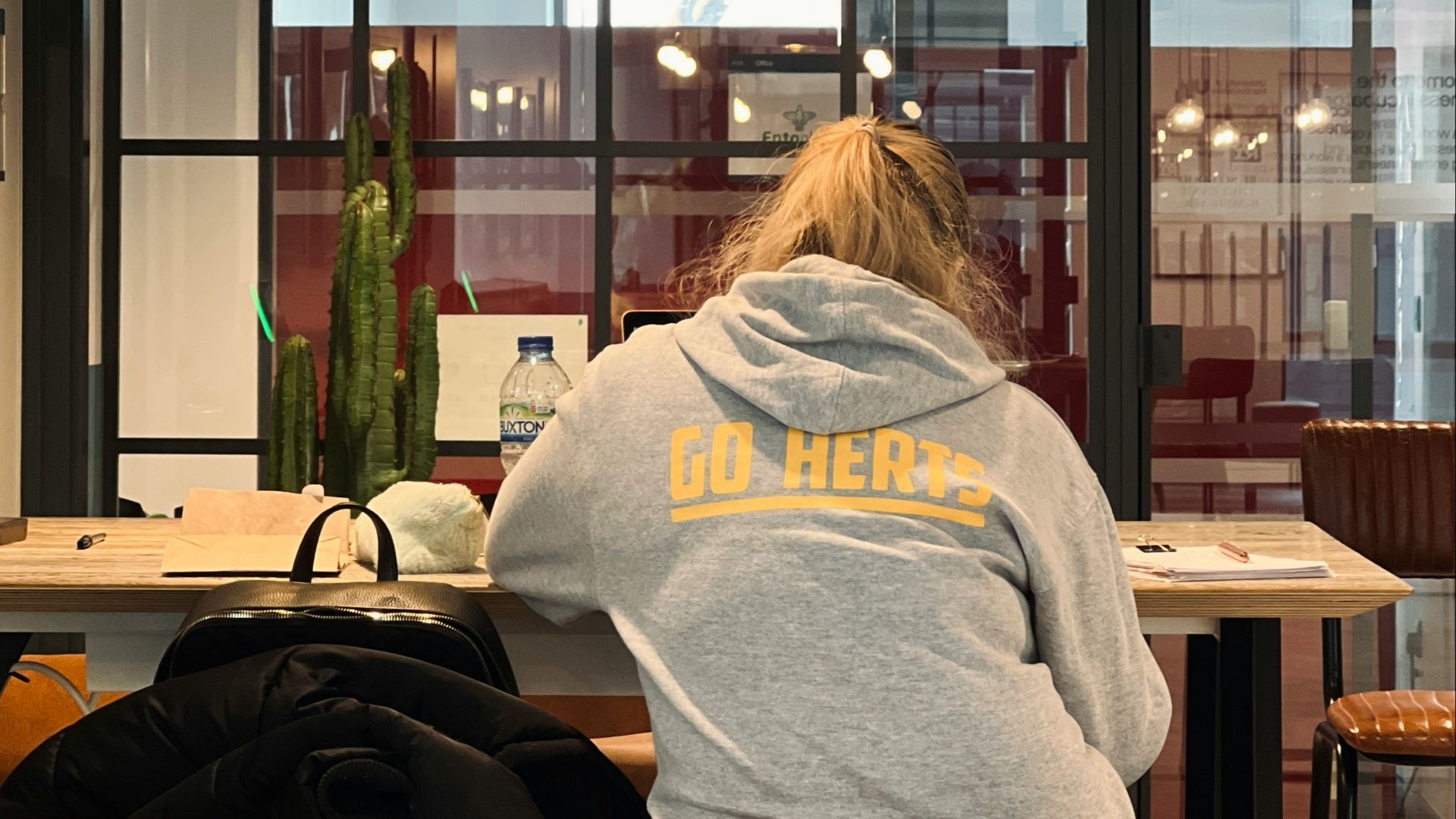 a person sitting at a table with a backpack