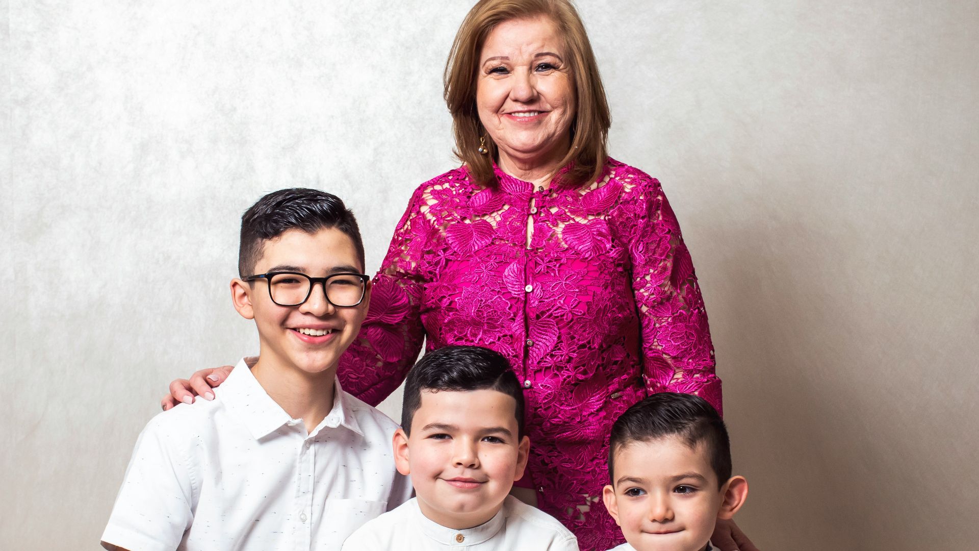 a woman and two boys are posing for a picture