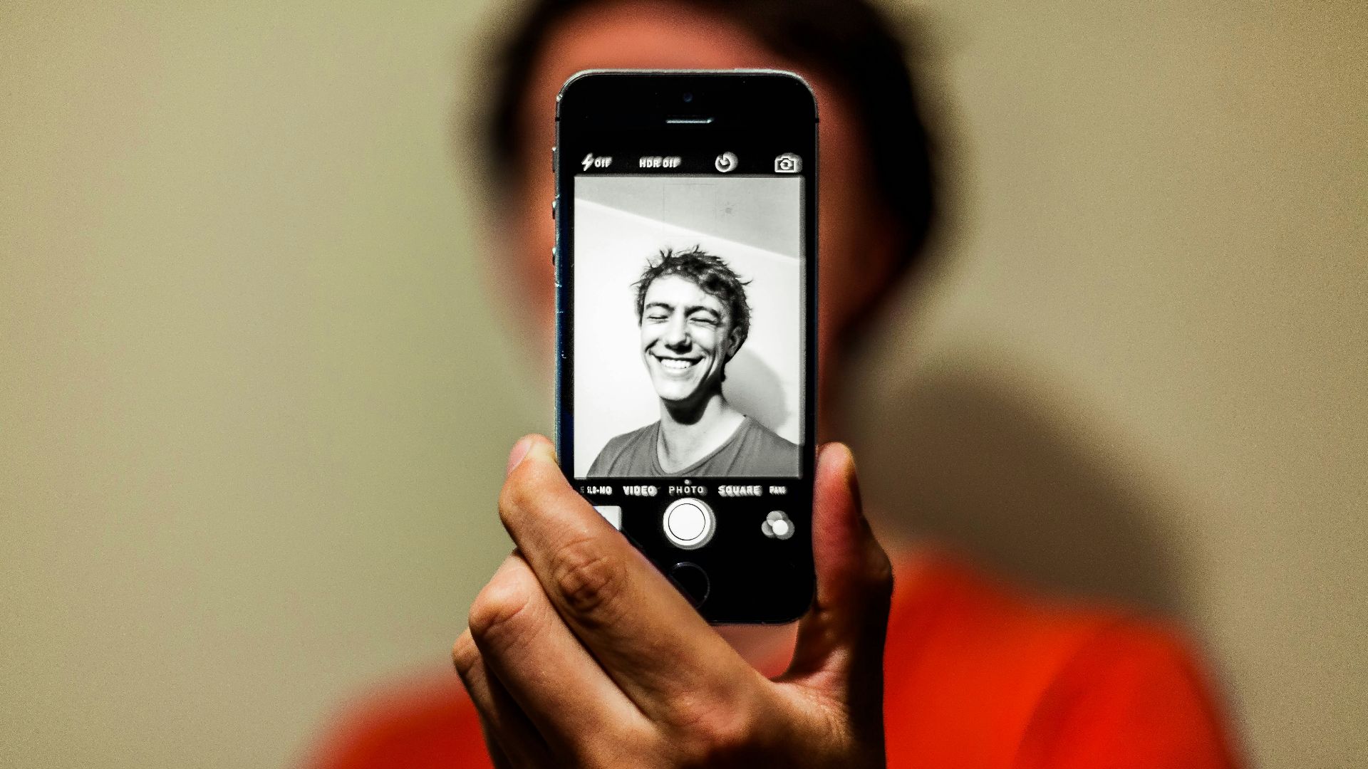 person holding space gray iPhone 5s taking picture