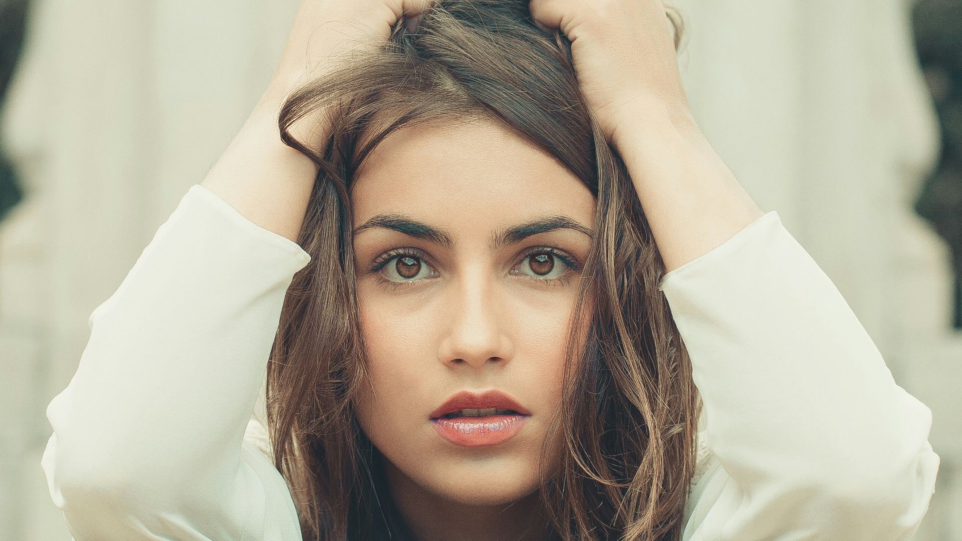 woman in white long sleeve shirt lying on bed