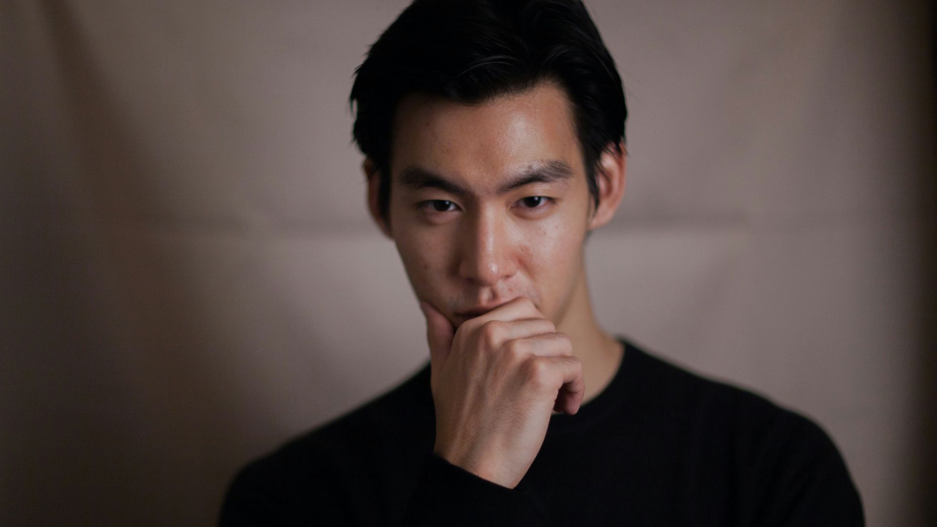 man touching his chin with right hand