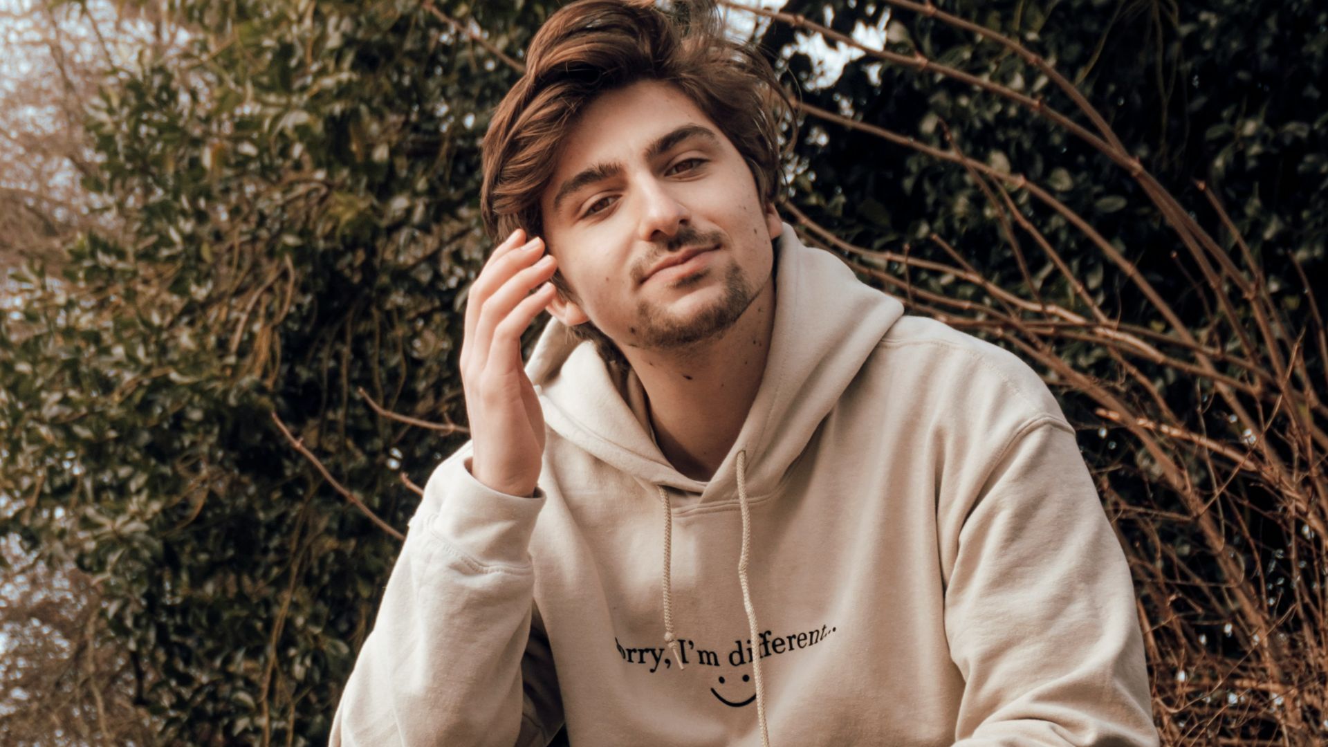 woman in gray hoodie sitting on black bench