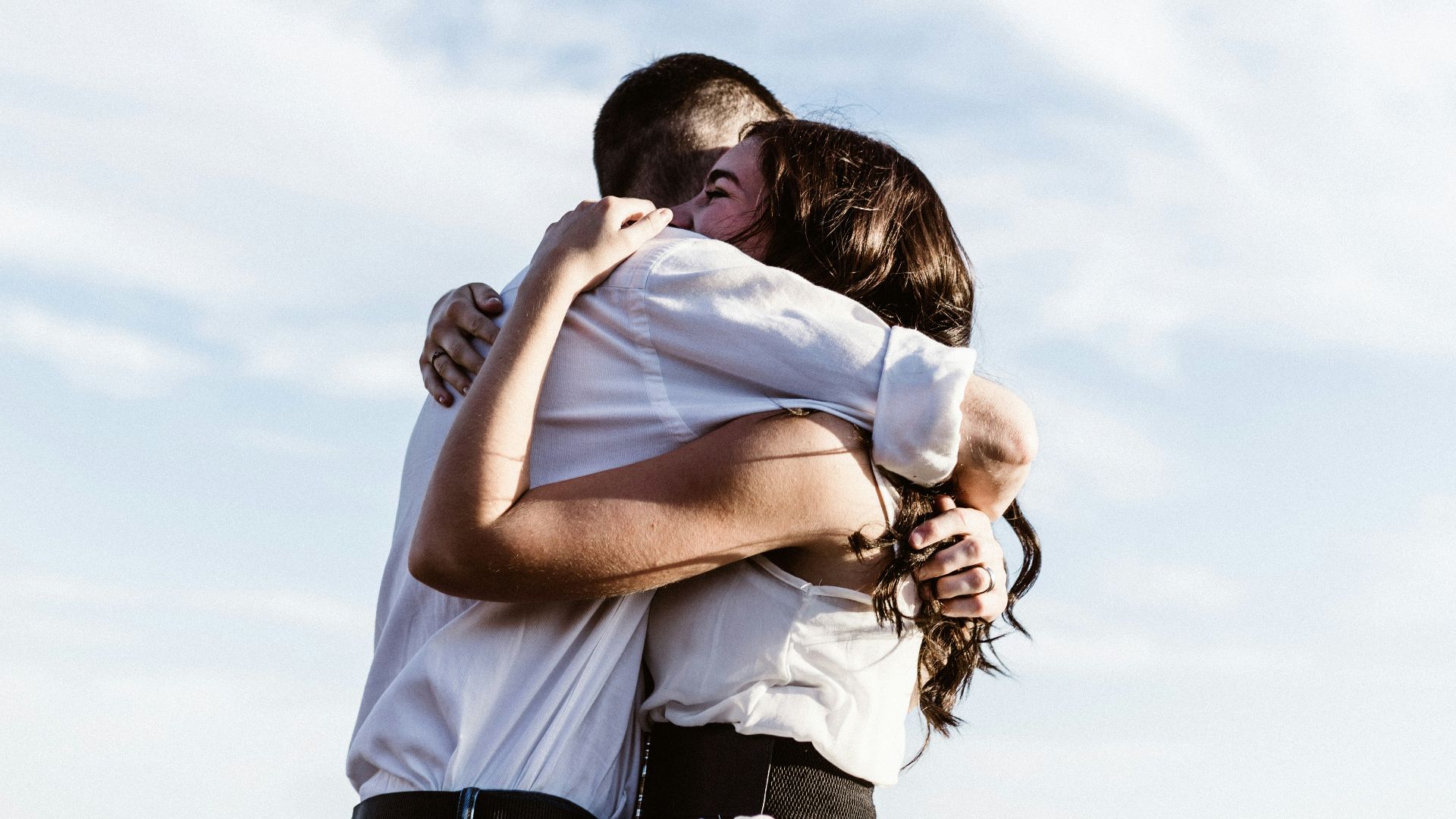 man and woman hugging each other photography