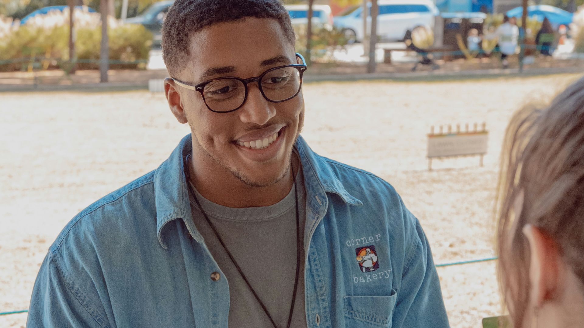 man wearing blue denim button-up shirt facing on human