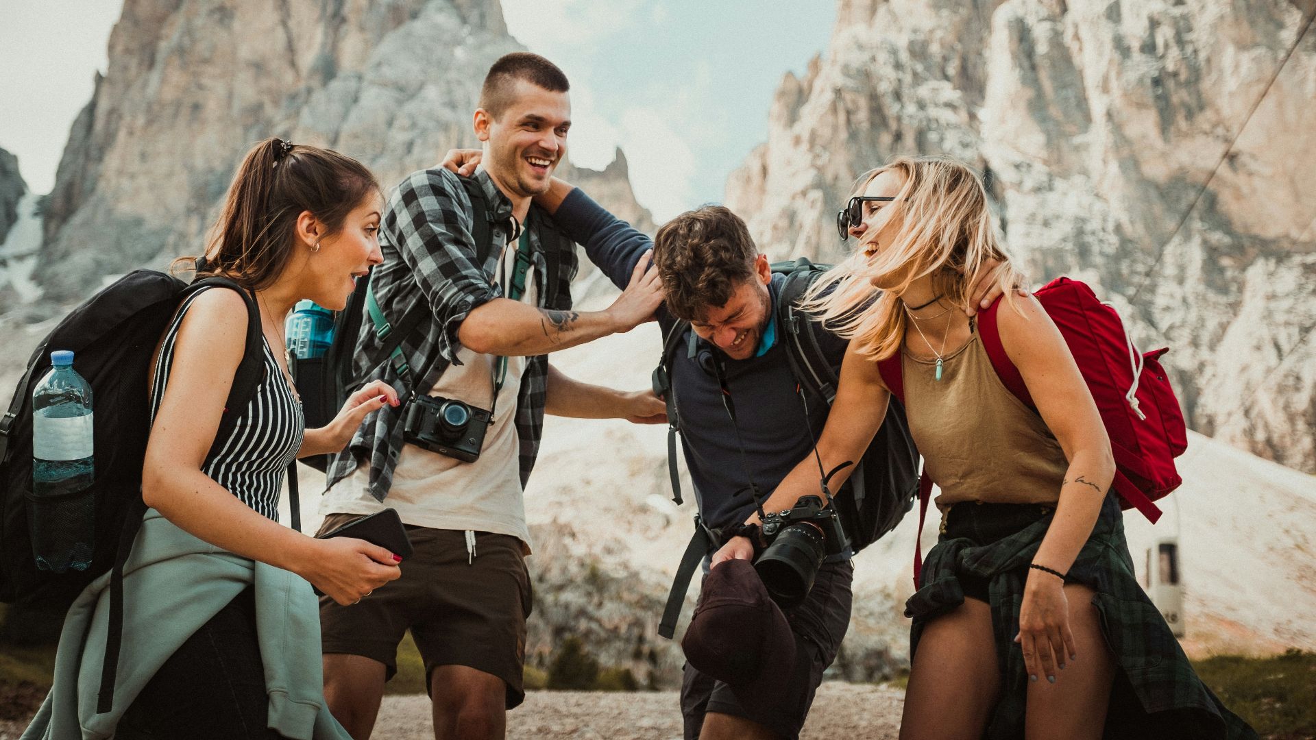 low-angle photography of two men playing beside two women