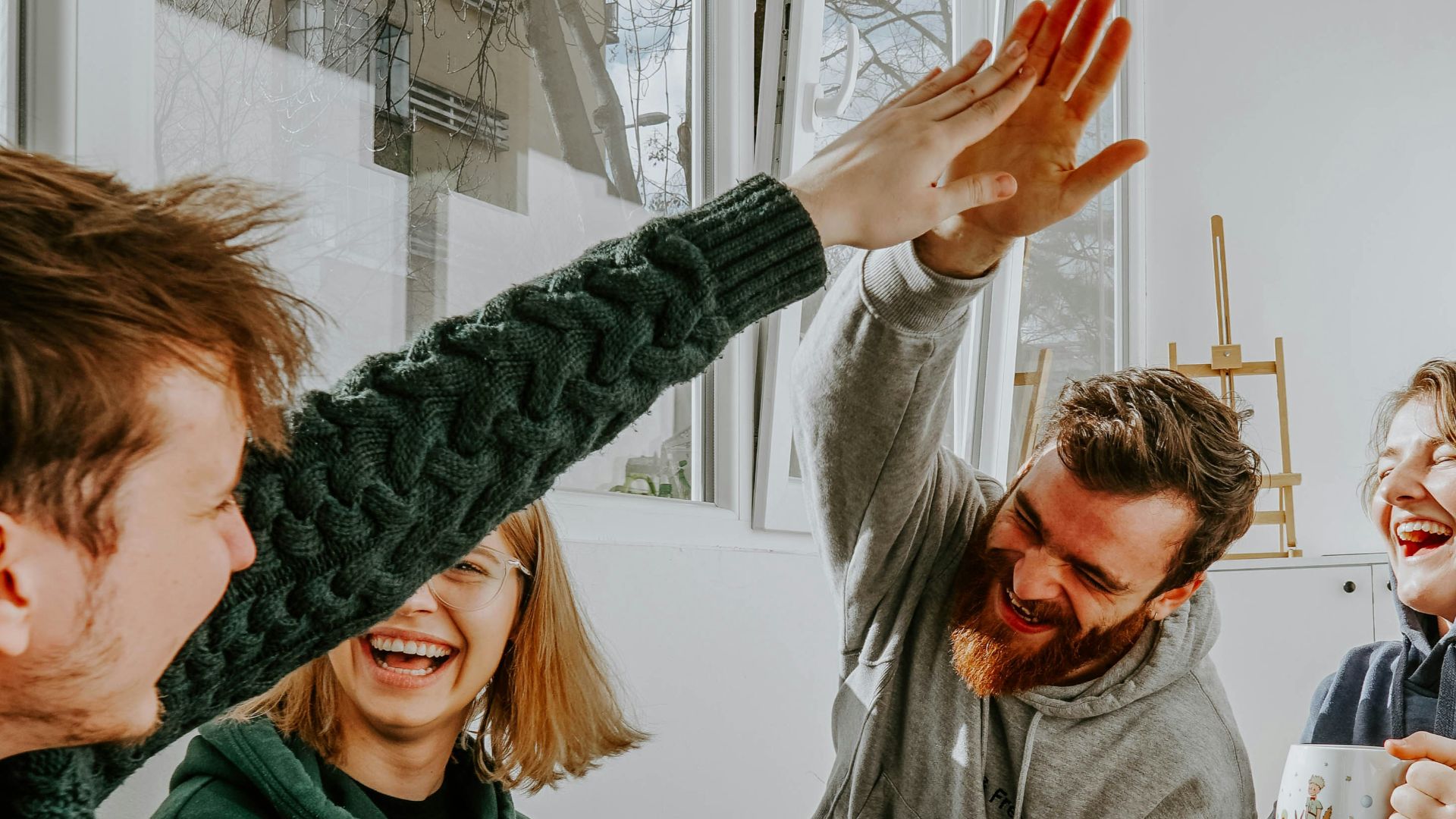 woman in black and white checkered long sleeve shirt sitting beside man in green crew neck