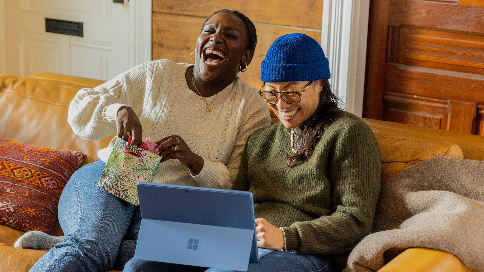 a person sitting on a couch with a laptop
