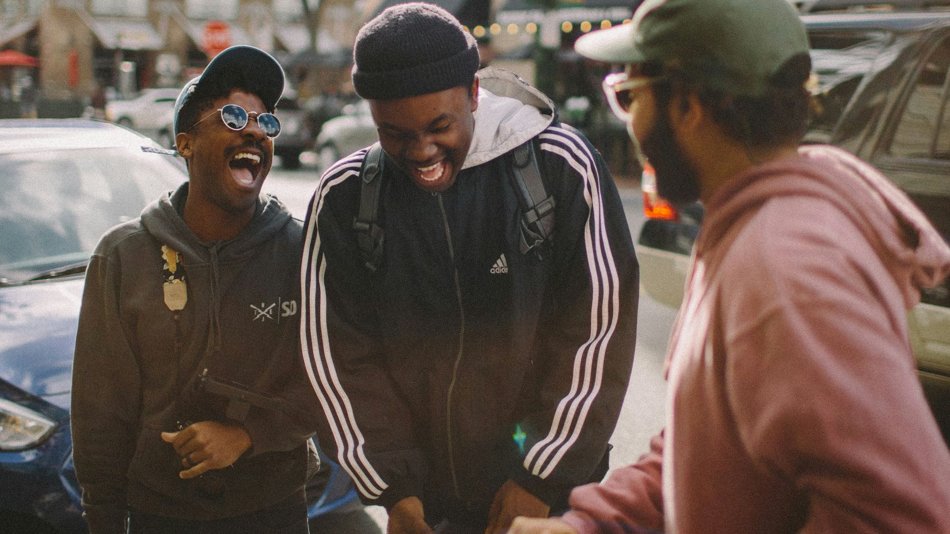 three men in jacket laughing at each other