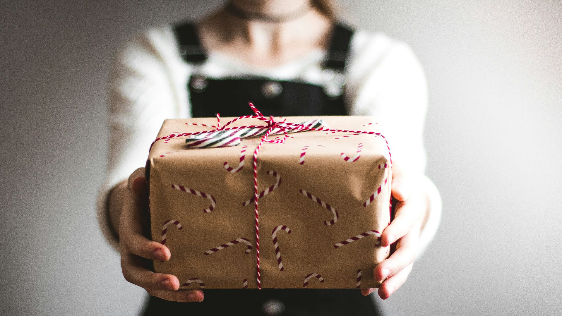 person showing brown gift box