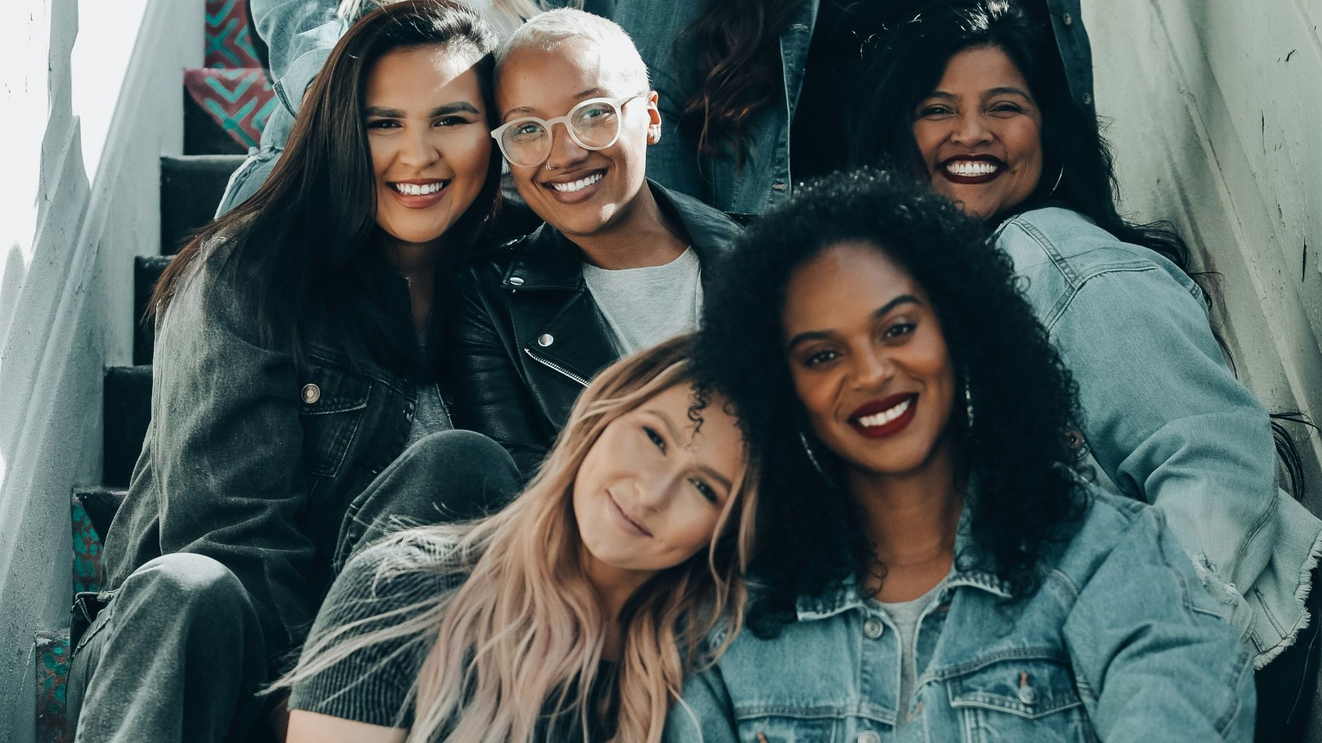 2 women sitting on black chair