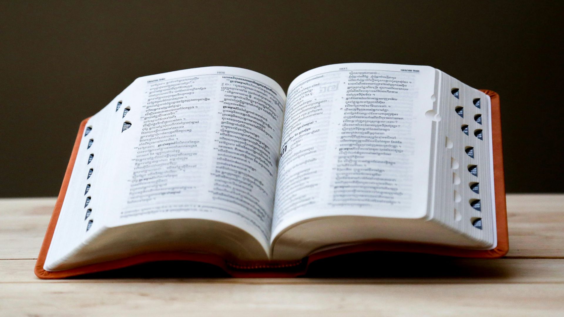 opened book on brown table
