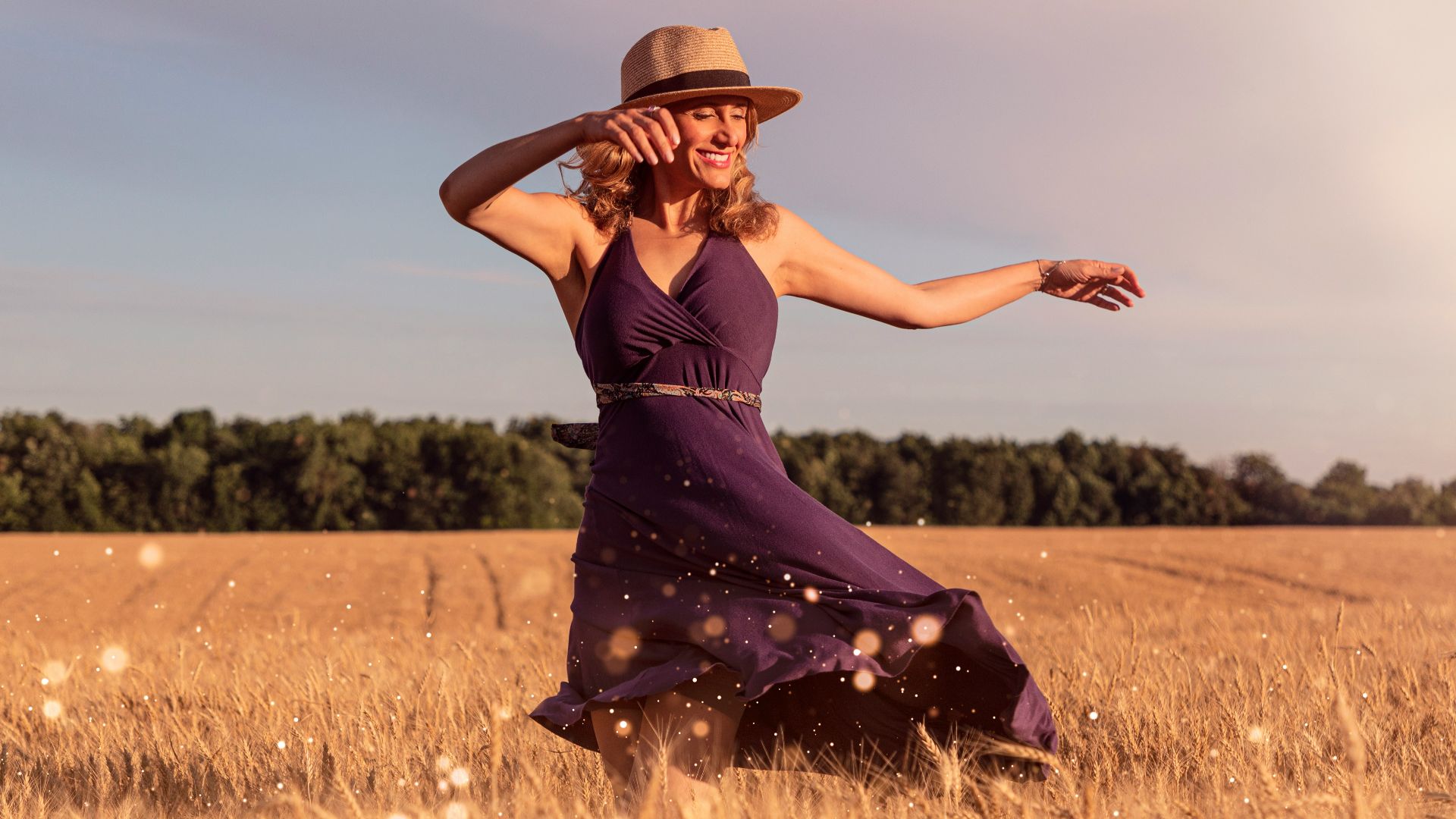 woman in brown sun hat standing on wheat field during daytime