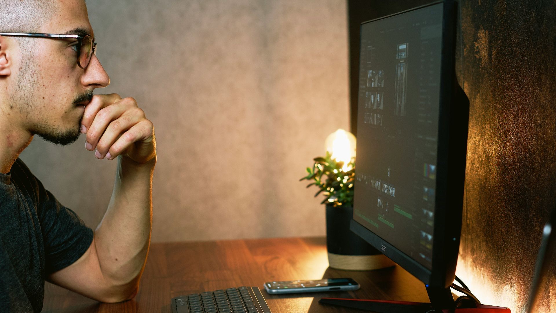 man in gray crew neck t-shirt using computer
