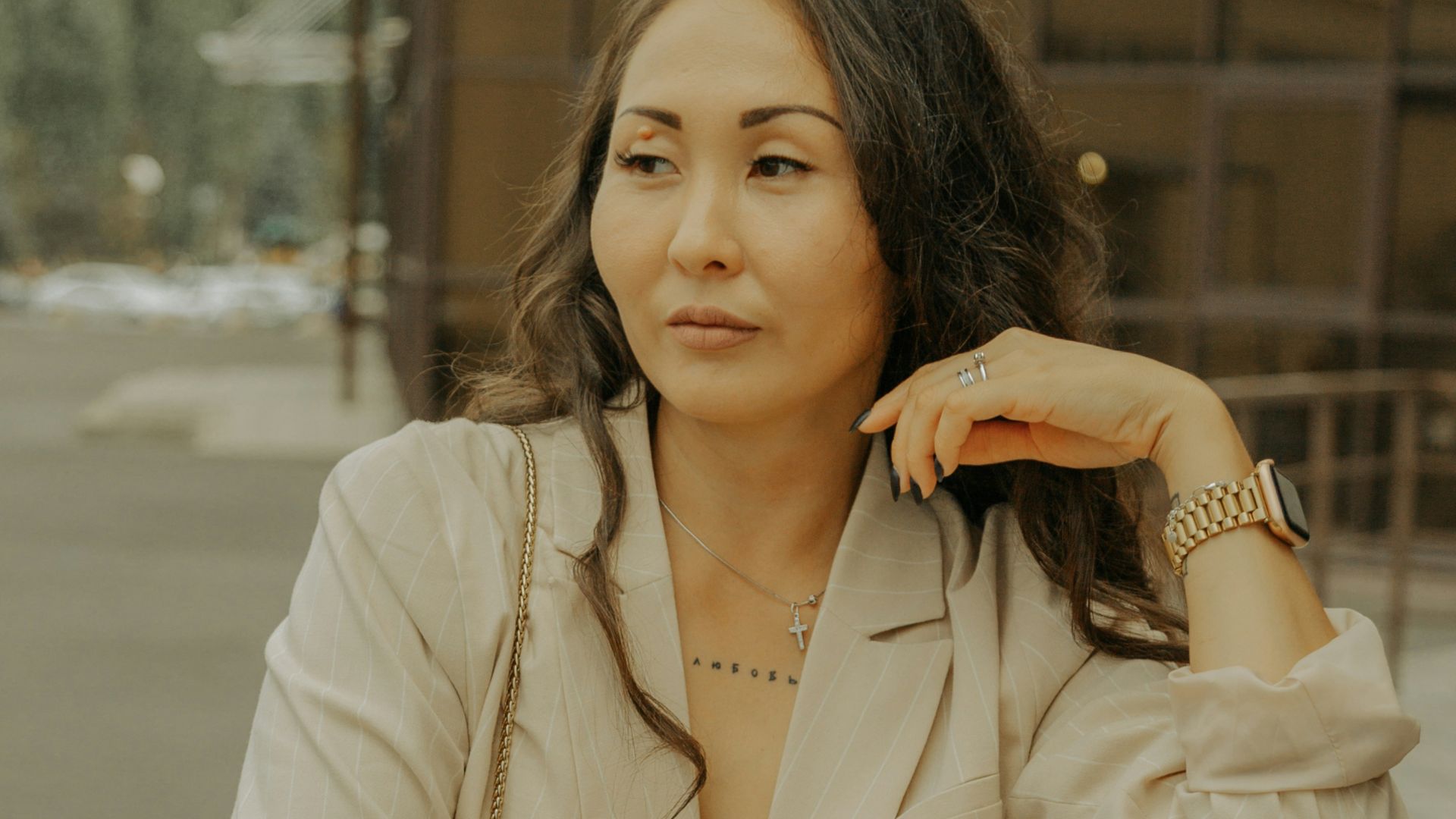 a woman leaning on a rail next to a building