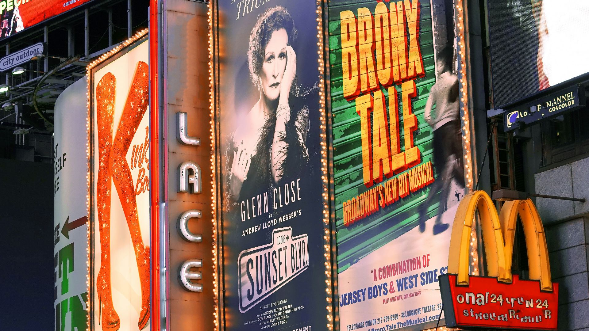 a bunch of billboards that are on the side of a building