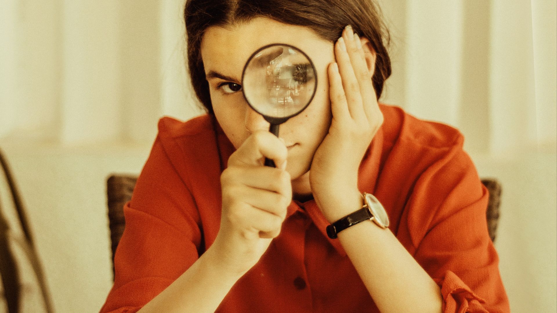 woman holding magnifying glass