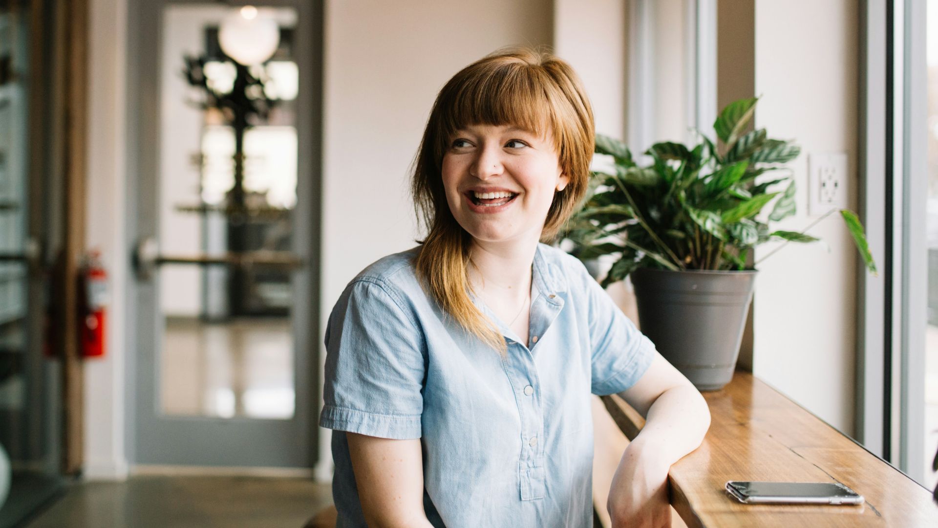 woman sitting in front of brown wooden table