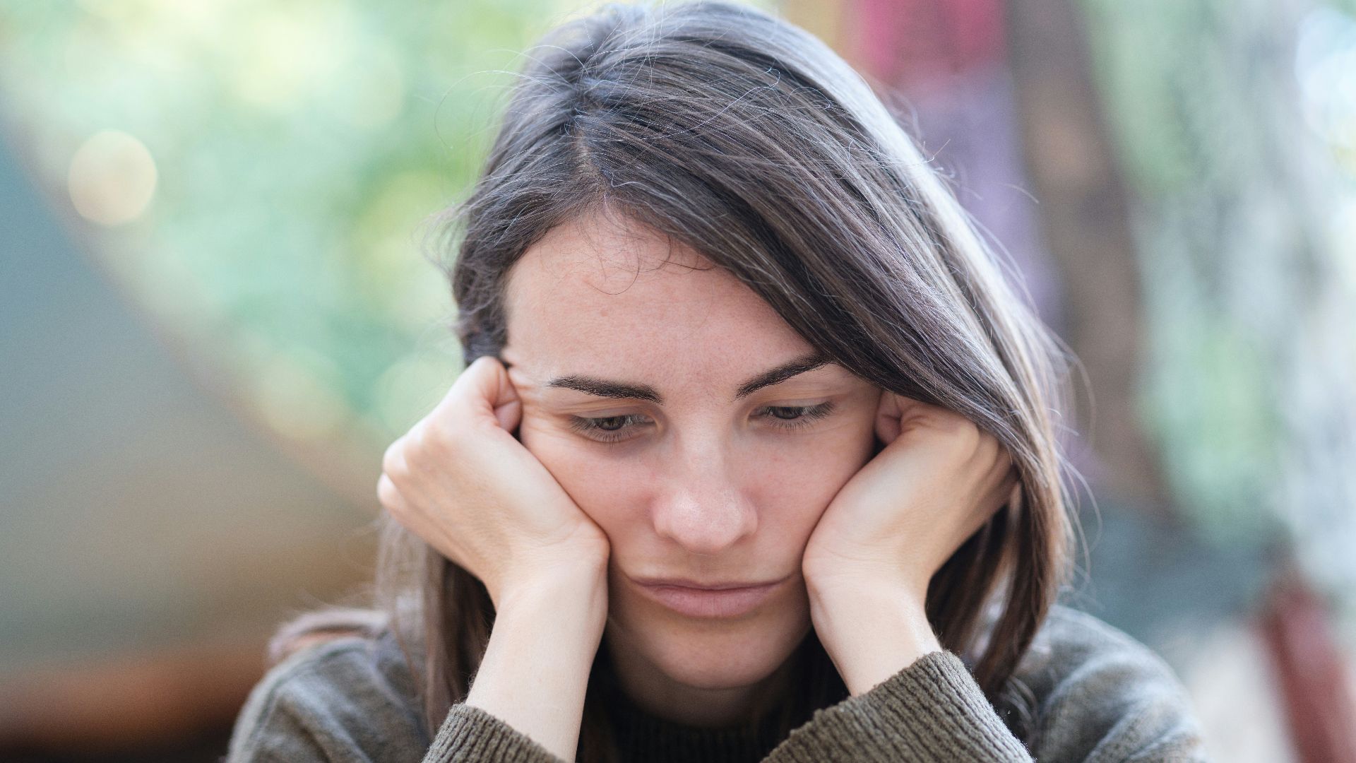 a woman holding her head in her hands