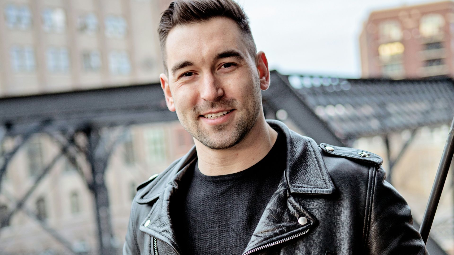 one unknown celebrity standing near black barrier