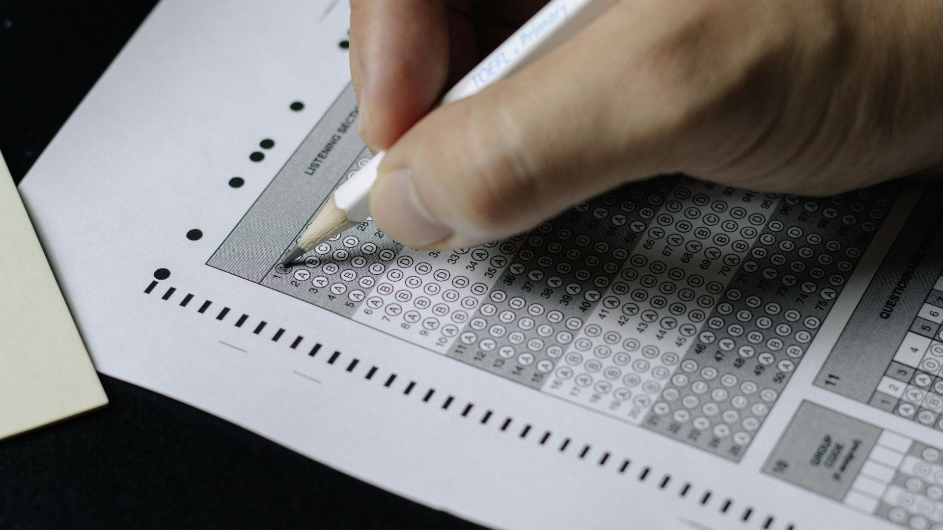 person writing on white paper