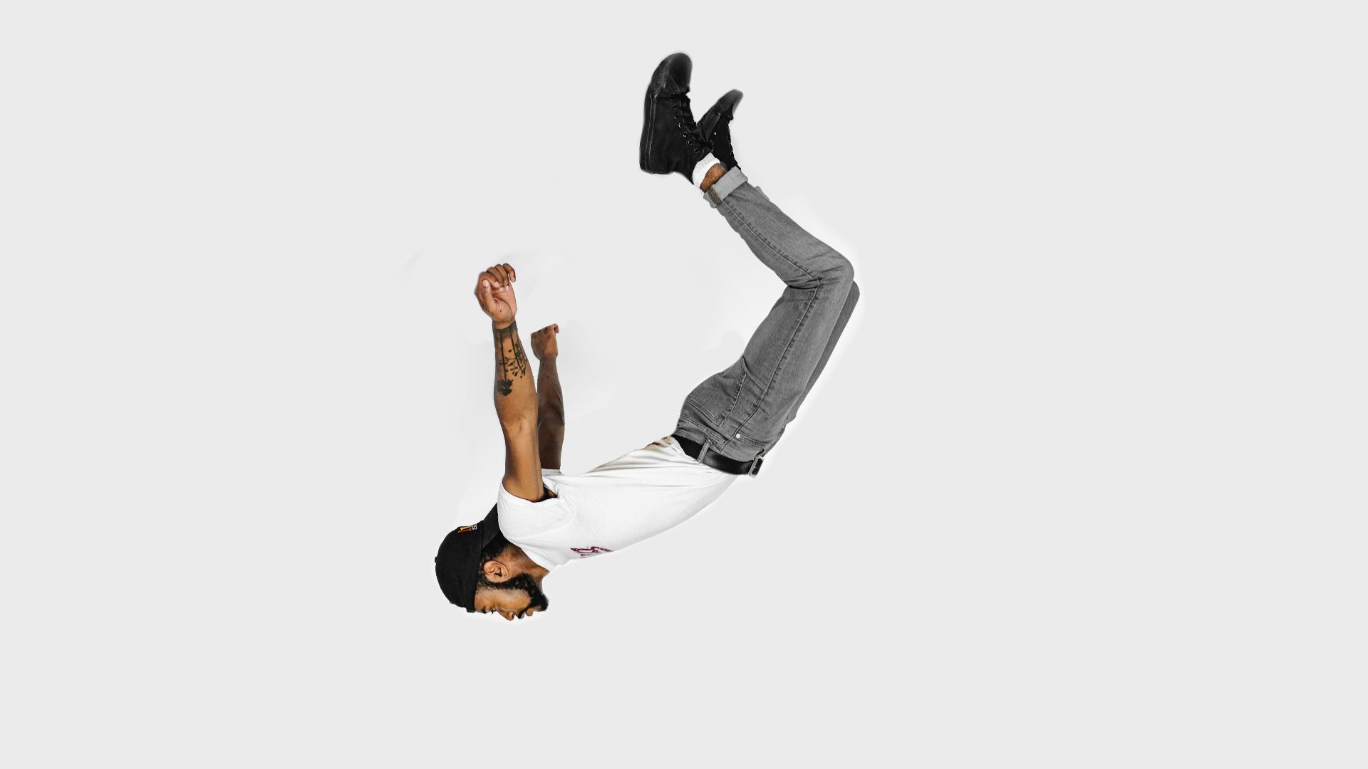 man in white shirt and gray jeans