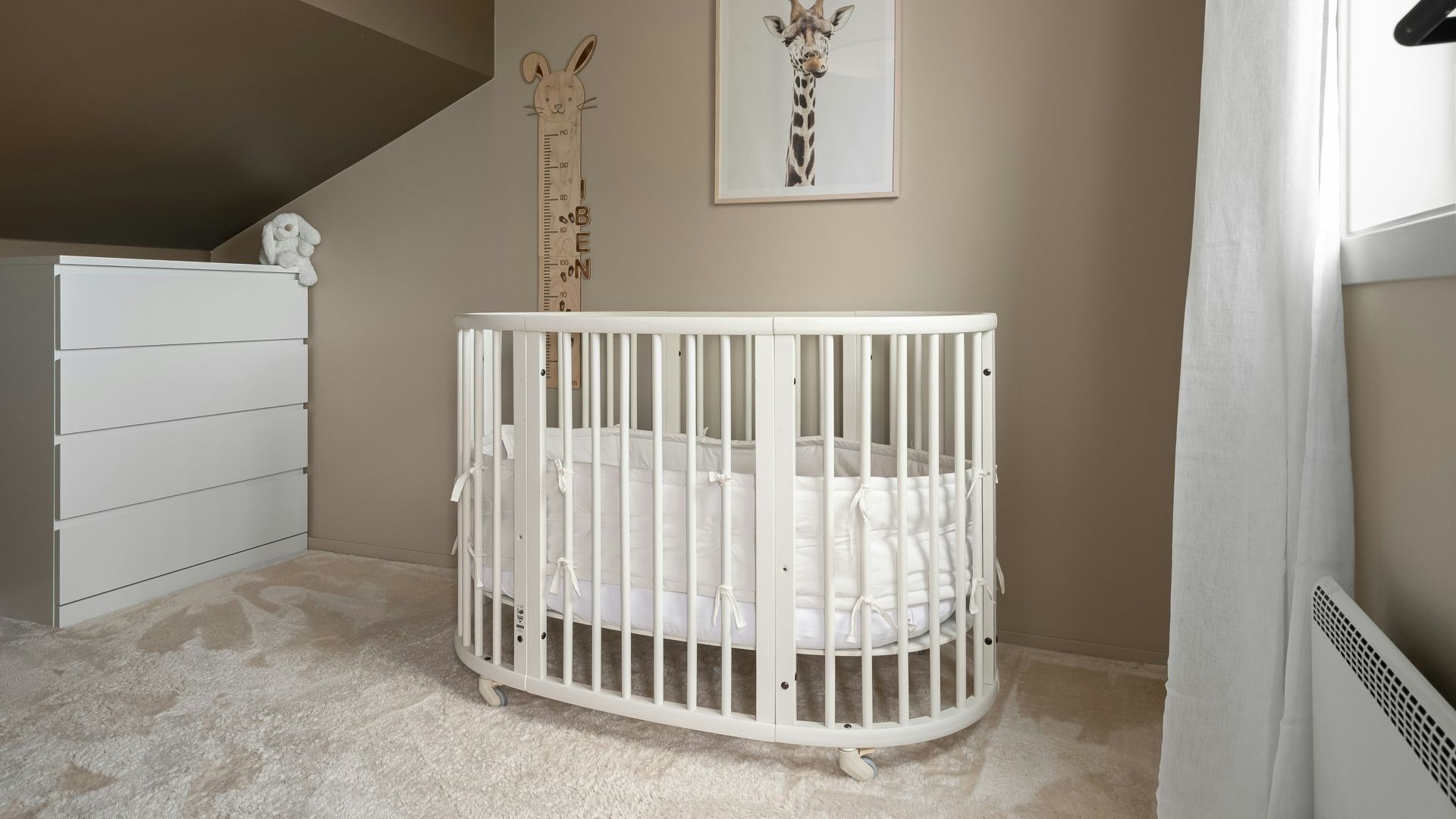A baby's room with a crib and a rocking chair