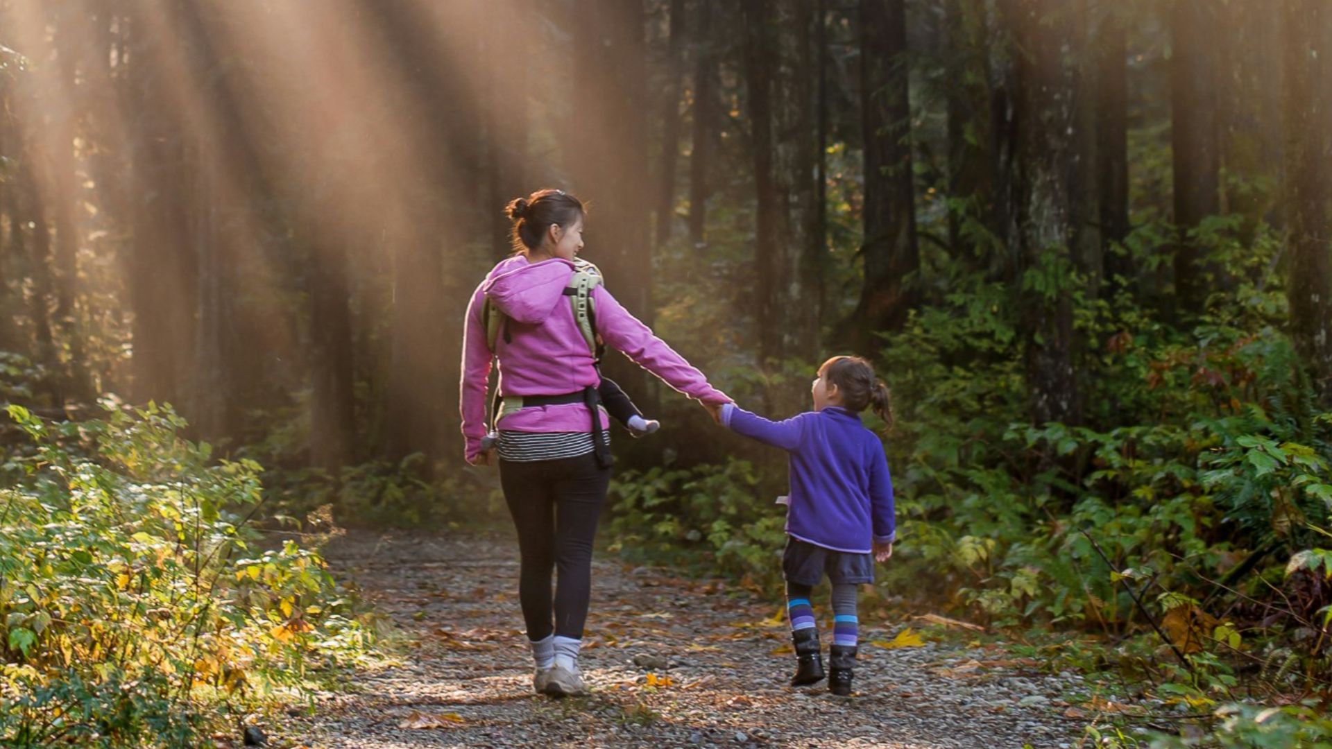 woman walking in forest with child