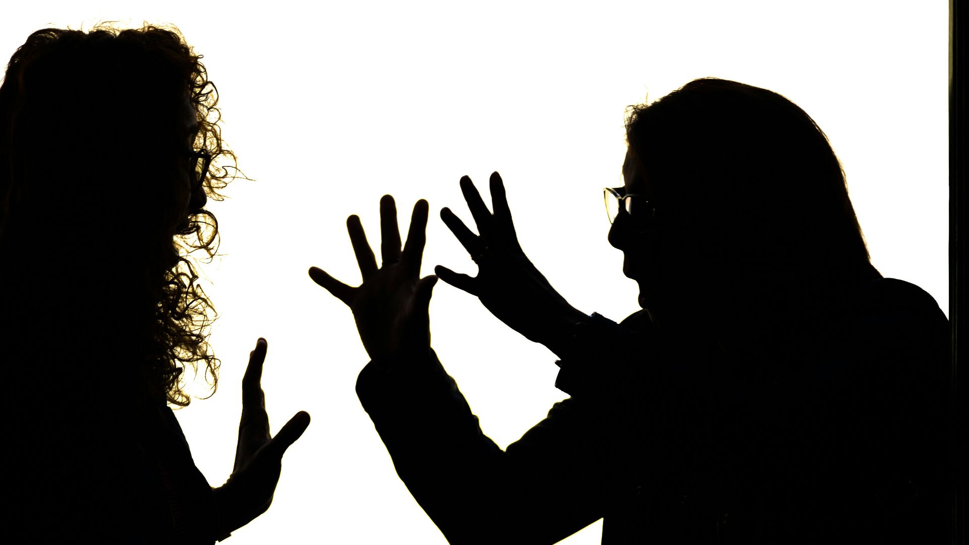 Silhouetted figures engage in a heated argument.