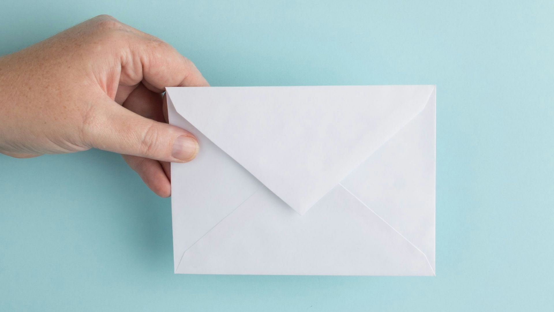 person showing white envelope