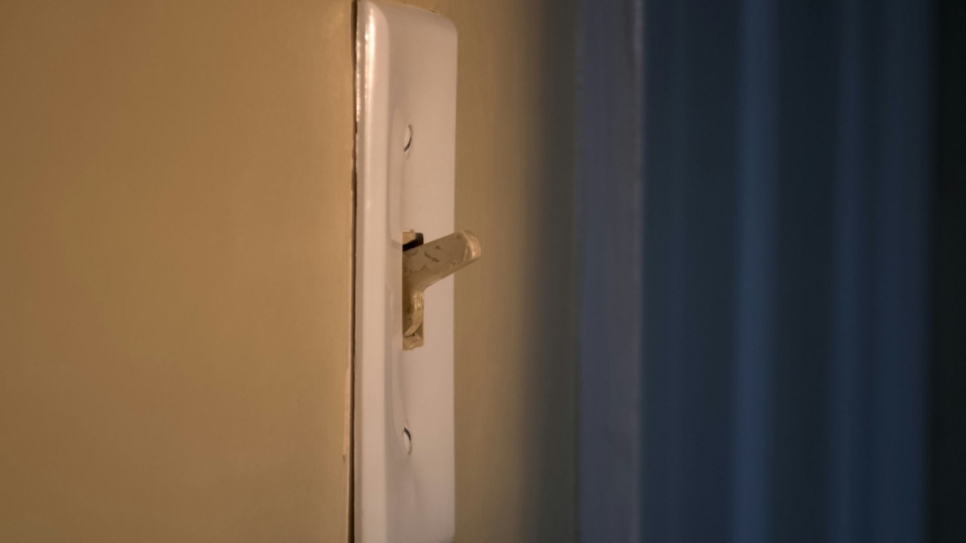 white switch mounted on blue wall