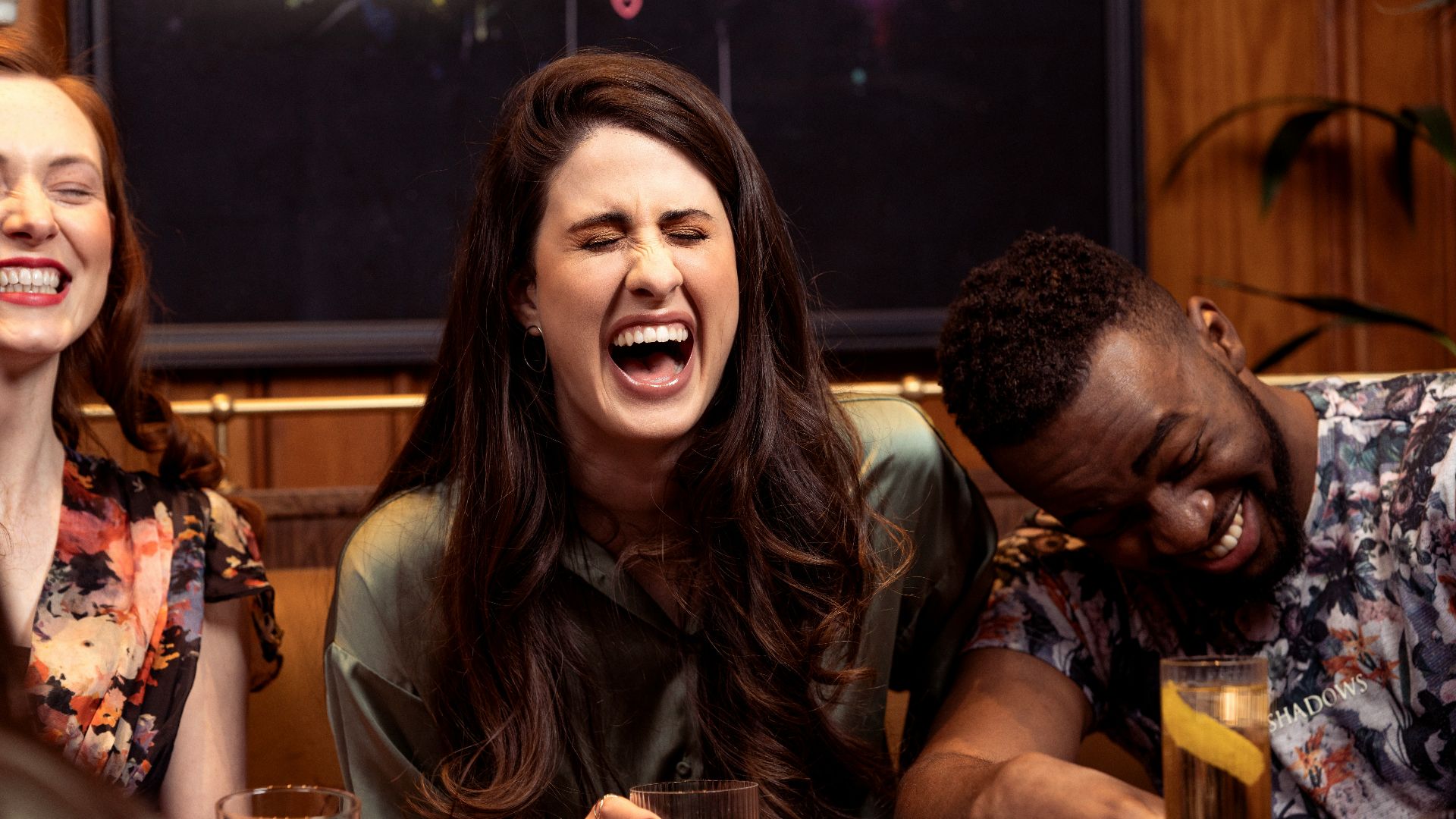 a group of people sitting around a table with drinks