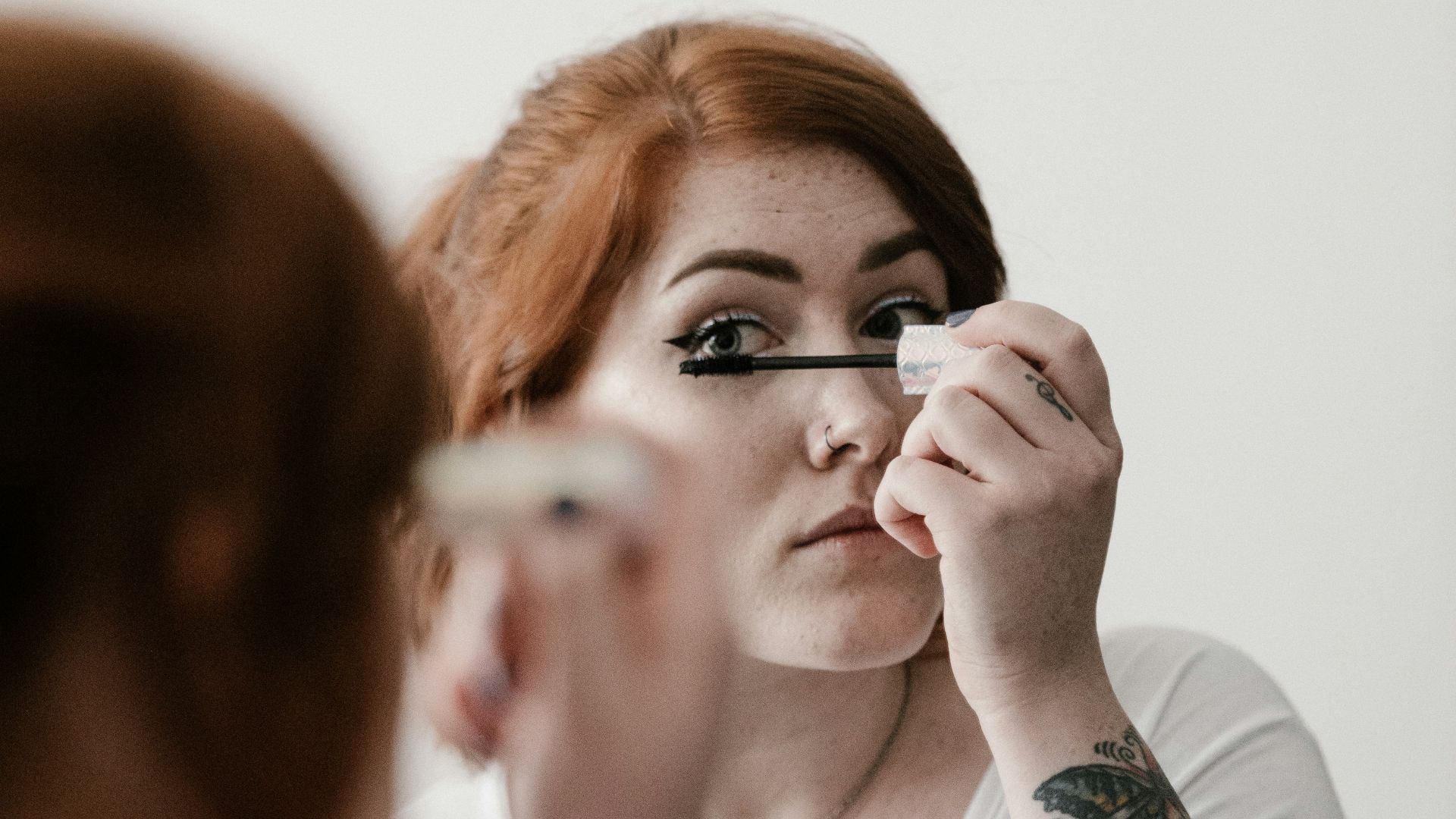 woman using makeup during daytime