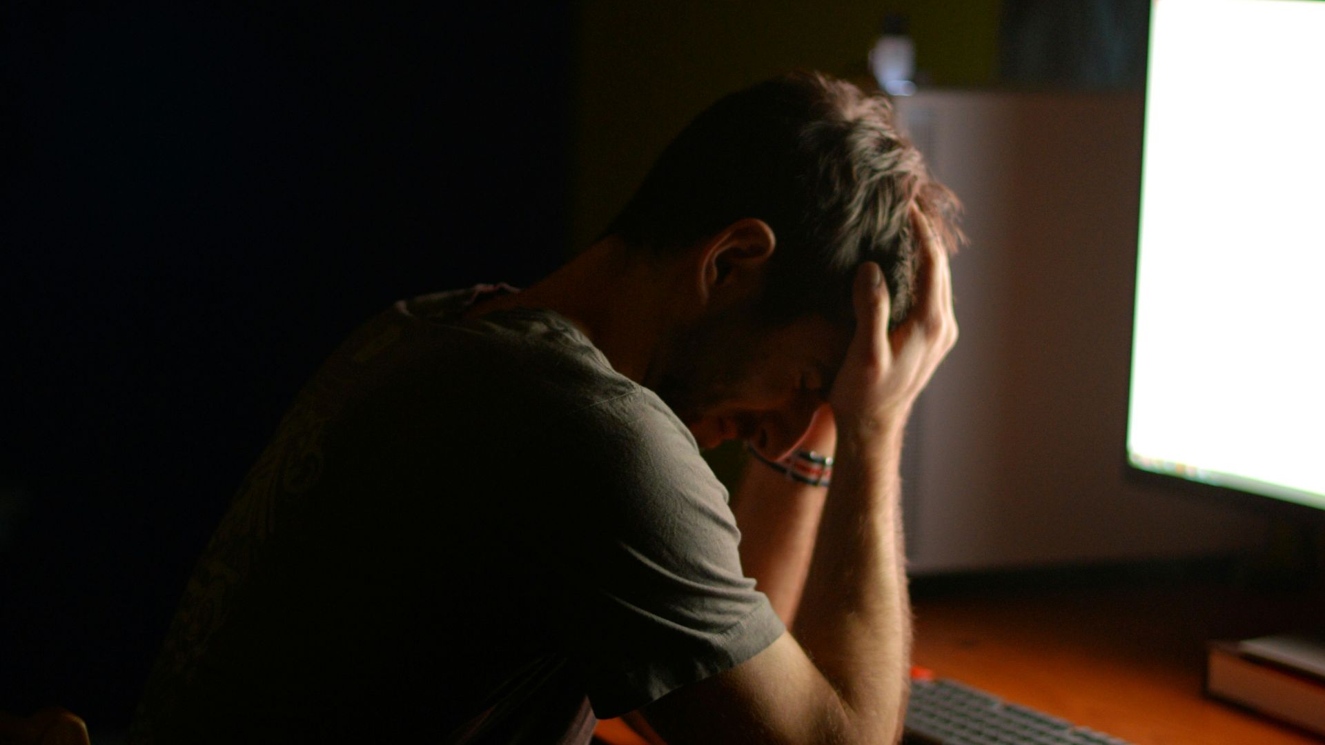 a man sitting at a desk in front of a computer