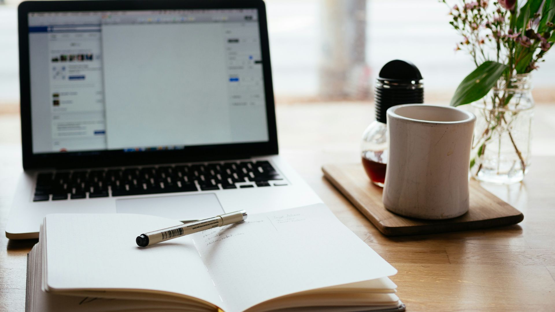 MacBook Pro near white open book