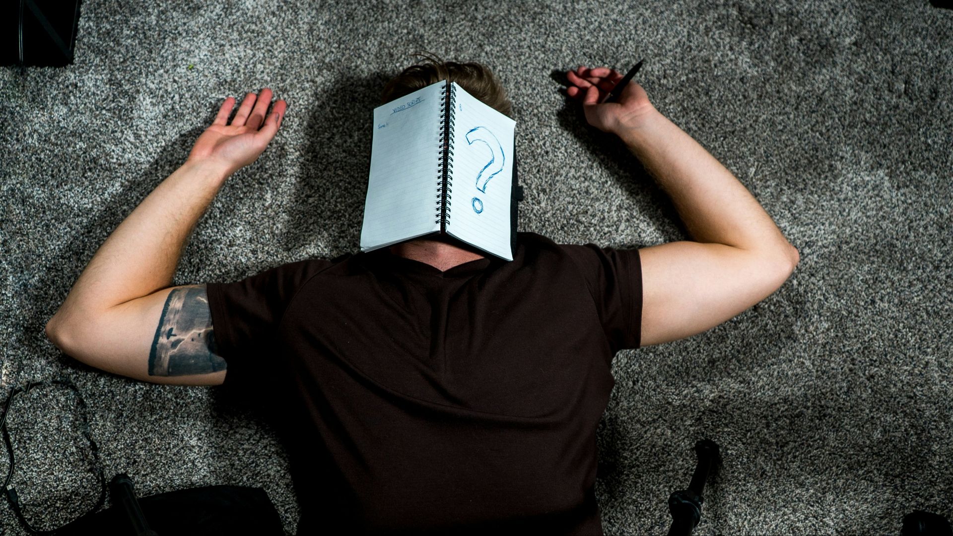 person in black shirt holding white paper
