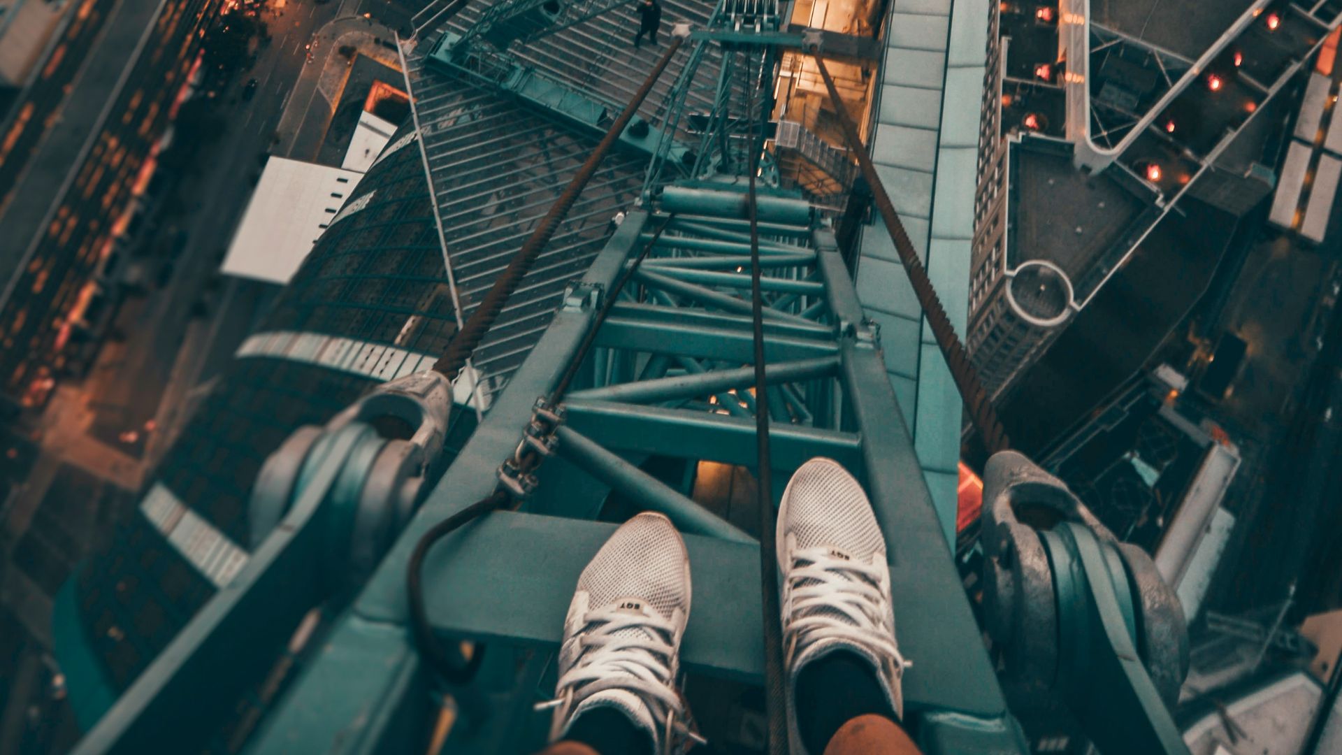 person standing on gray steel frame on top of building